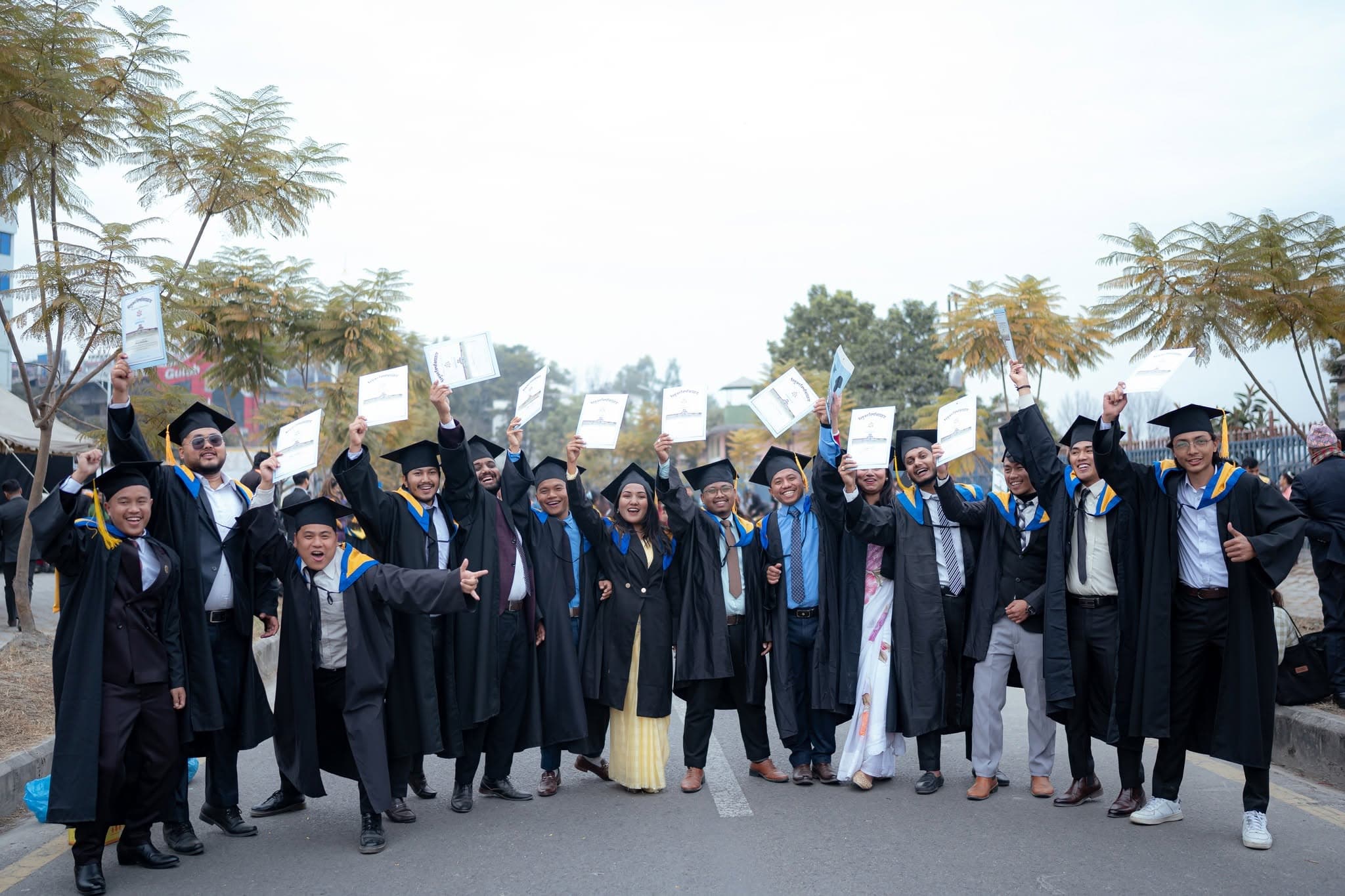 Graduates celebrating with their certificates