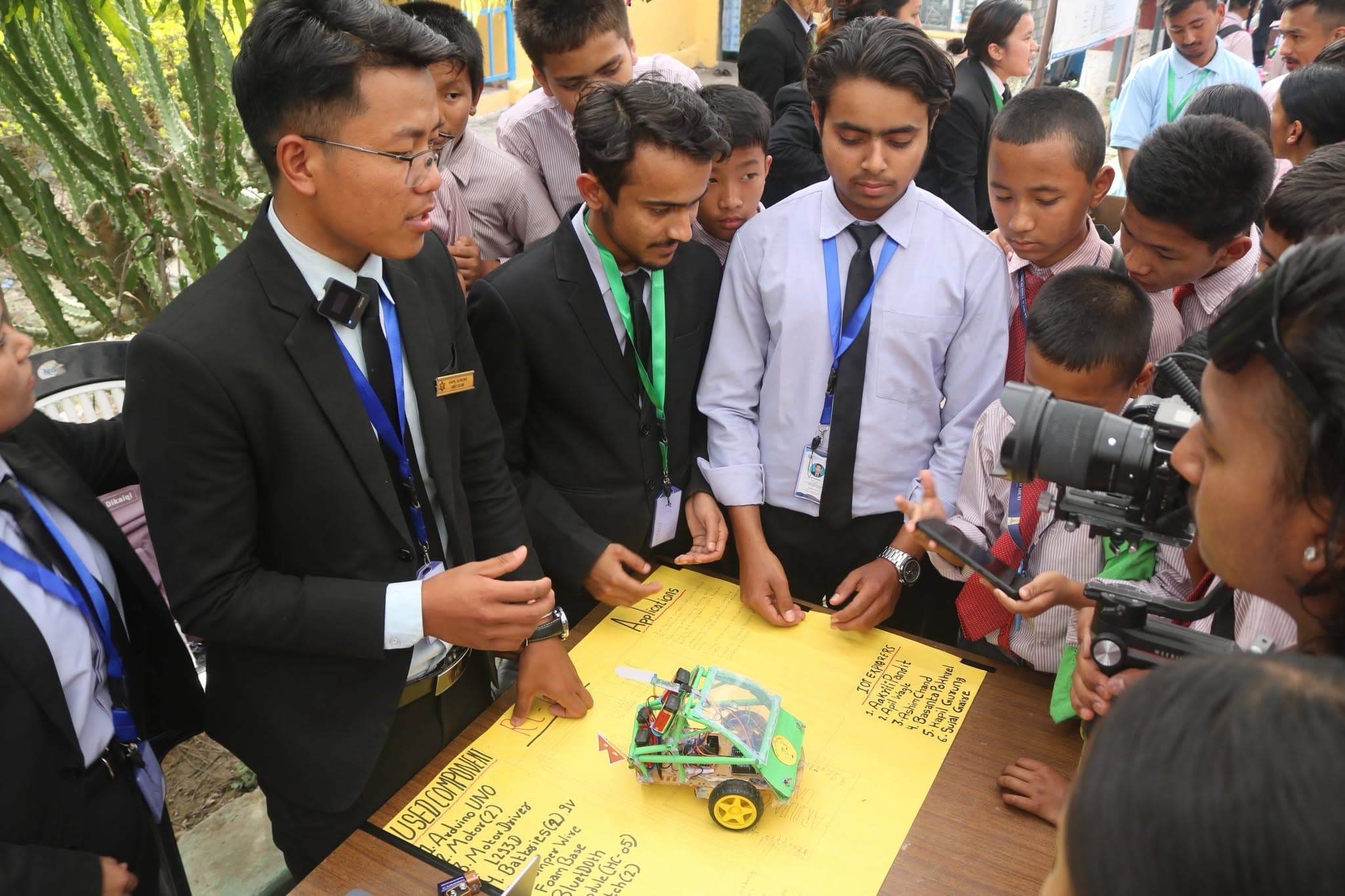 Students presenting an RC robotics project to visiting schools