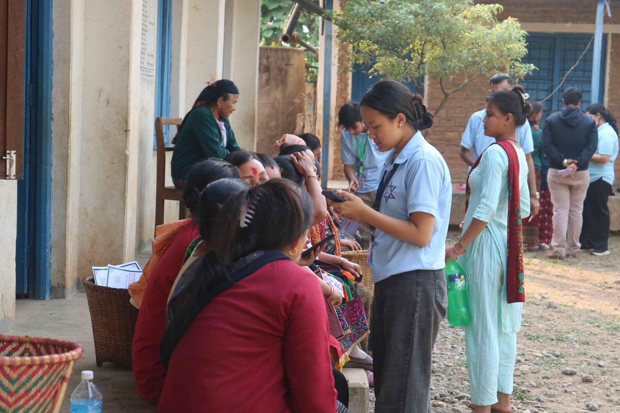 A student walking village womens through their phones