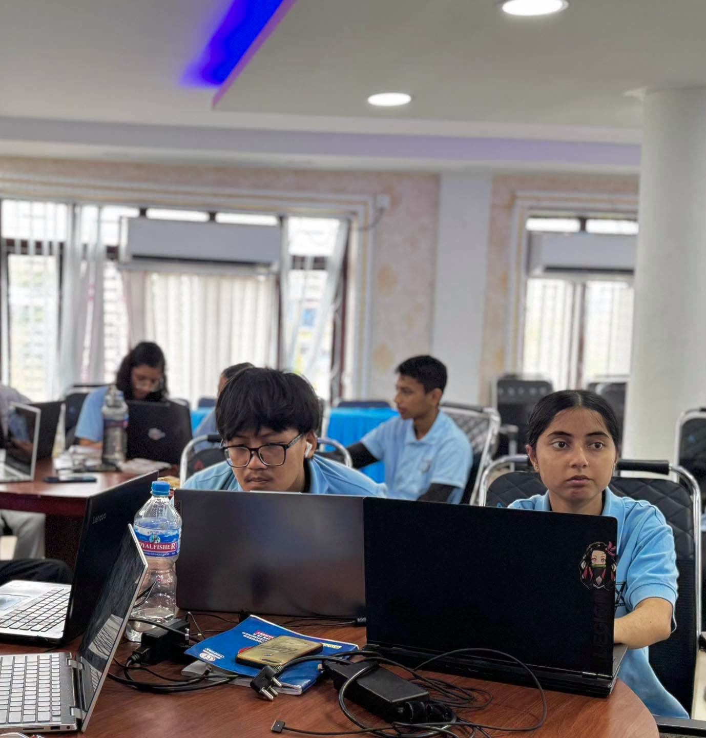 A full room of participants working on their own laptops