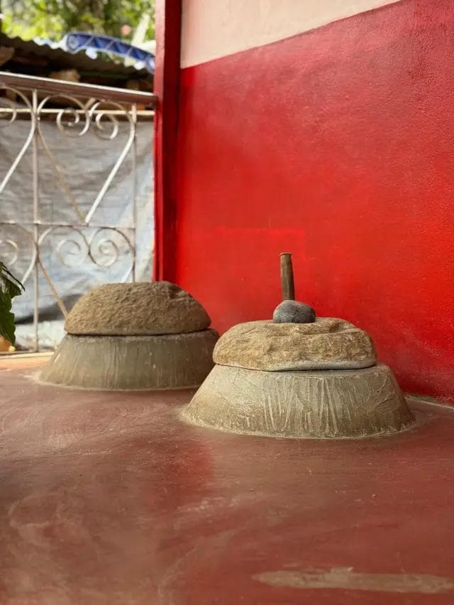 Stone jato grinders outside a village home