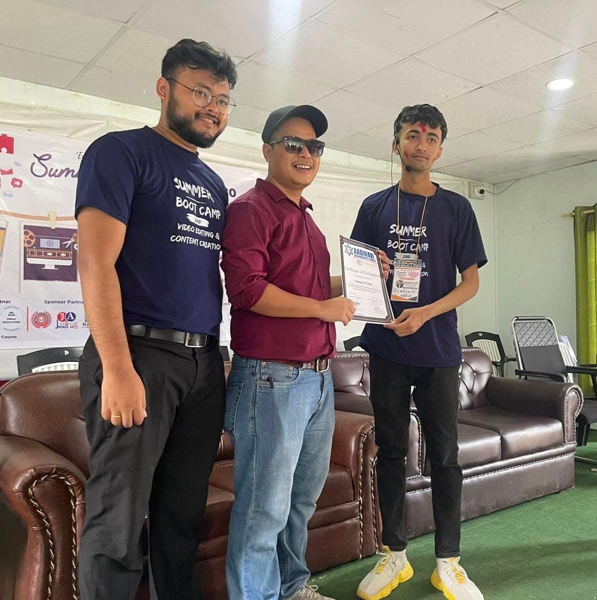 A participant receiving their certificate at the close of the bootcamp