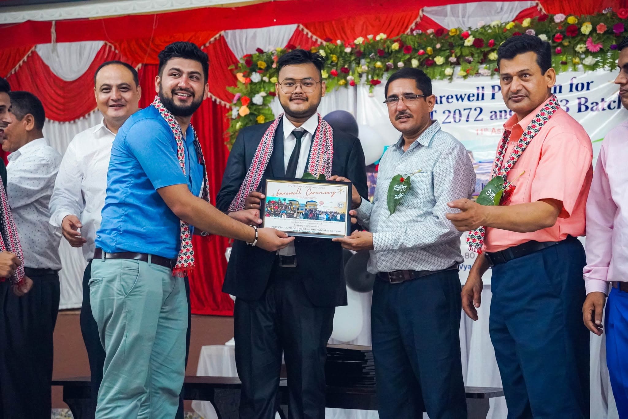 A graduating student receiving their farewell frame